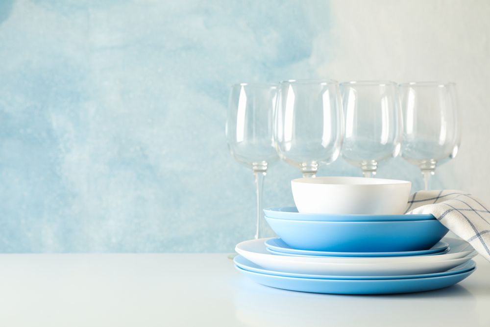 Cutlery beautifully stacked on table against blue background
