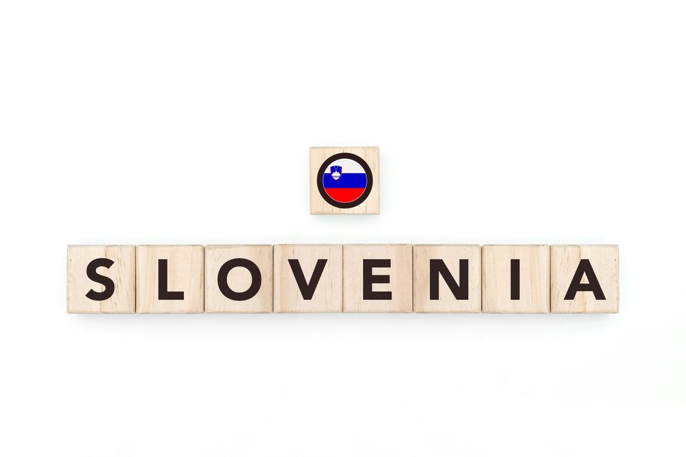 Wooden blocks bearing the name and flag of Slovenia. Sloven and East European Culture, national identity, travel, and geography in a copy space design.