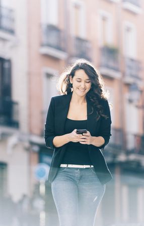 Young female walking with smartphone