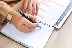 Person taking note of histogram