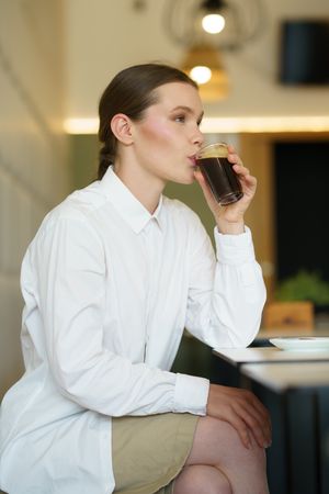 Woman sipping cold brew in cafe