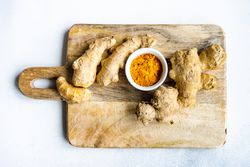 Top view of raw ginger & turmeric on board