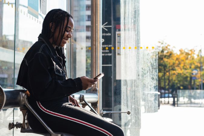 Happy female on bus stop