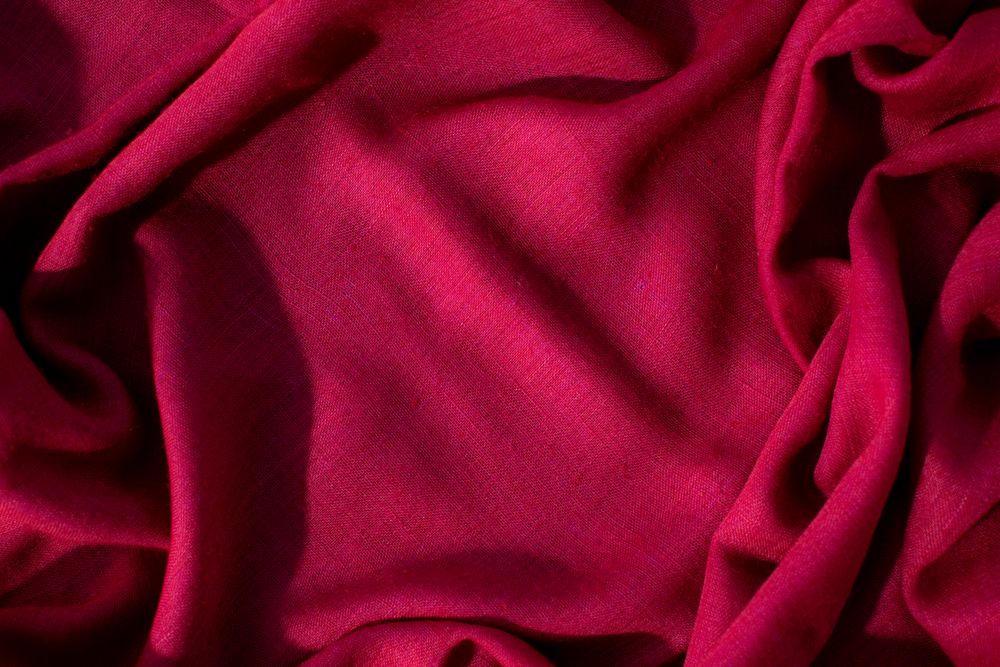 Red fabric wavy crumpled background texture with copy space.