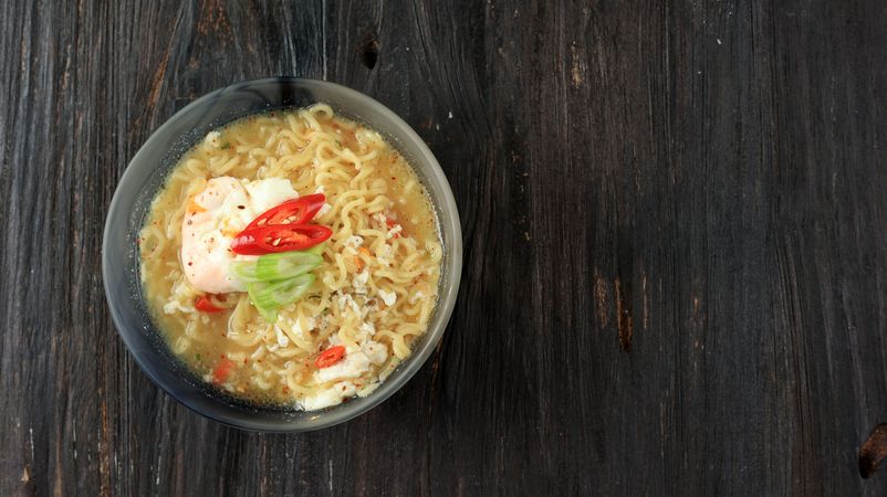 Top view of bowl of instant ramen noodles with egg and vegetables