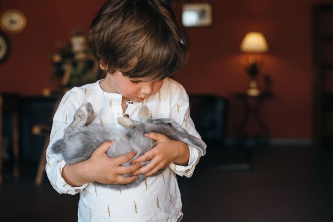 Charming boy with furry bunny