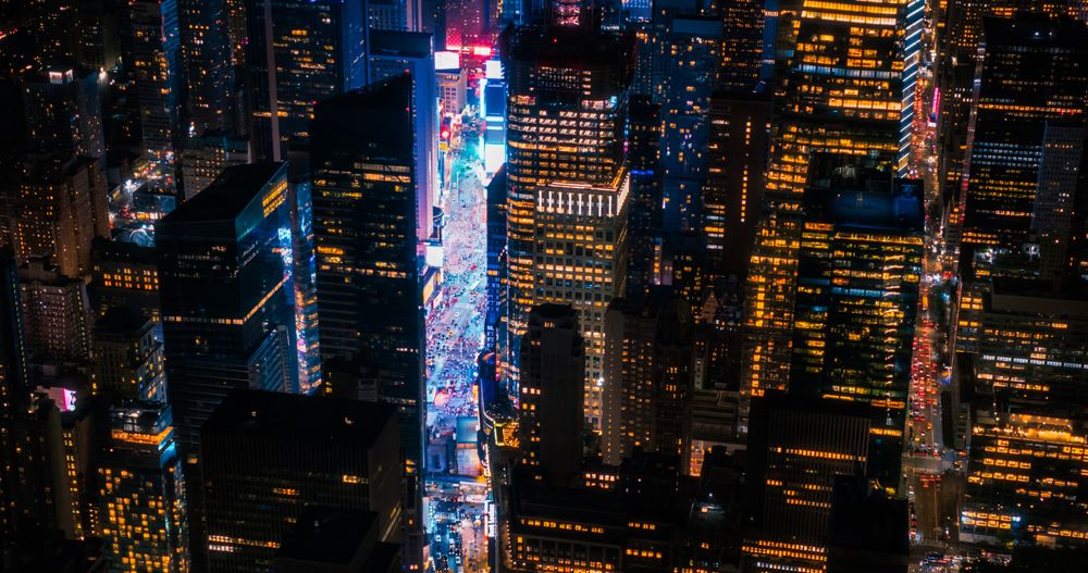 New York Concrete Jungle at Night. Aerial Shot from a Helicopter Tour Around Manhattan. Scenes with Modern Skyscraper Blocking the View on Crowded Times Square Area with Tourists