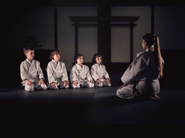 Krav Maga trainer with group of kids in studio