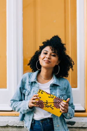 Stylish female by yellow door
