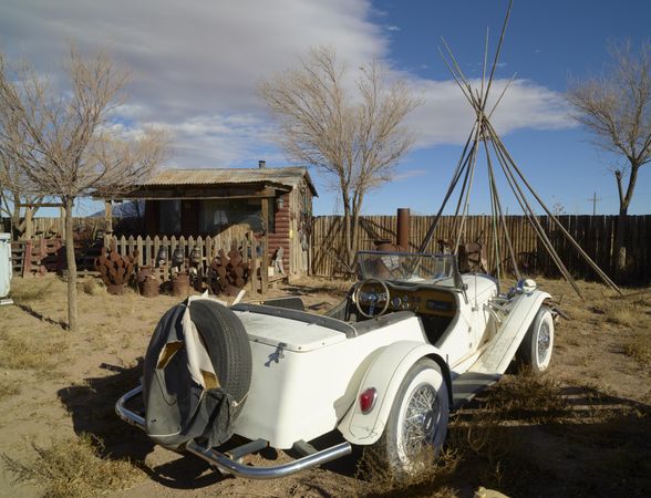 Vintage car with wood forming a teepee