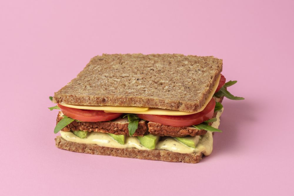 Vegan sandwich isolated on pink background