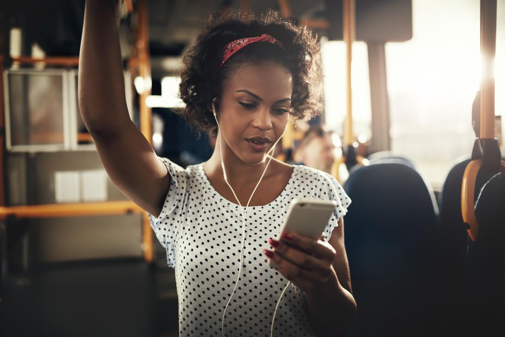 Woman listening to phone while on public transport