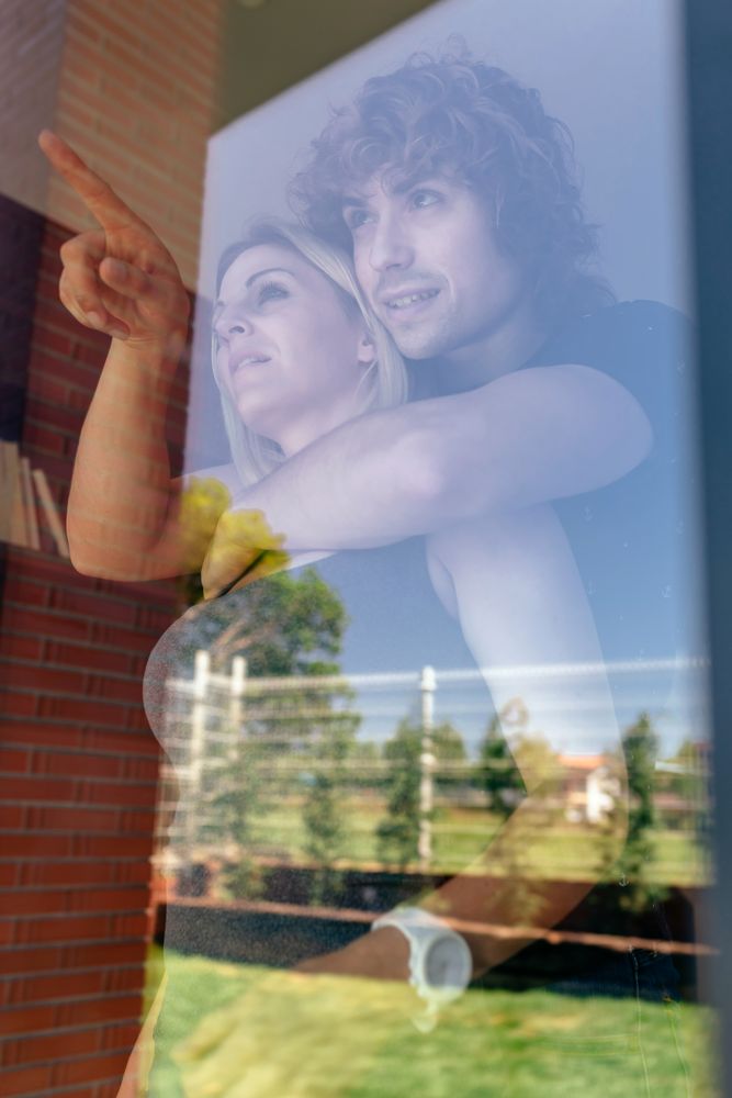 Couple looking at the garden through the window