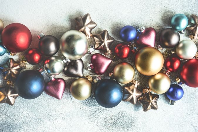Flatlay of colorful Christmas baubles on table