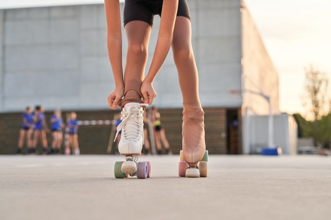 Anonymous girl puling leggings on roller skate