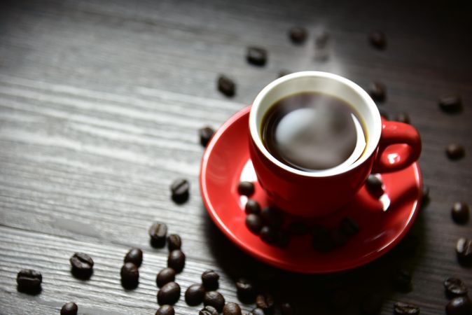 Top view of small red espresso cup, copy space