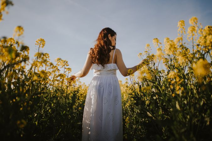 Woman with flowers in field
