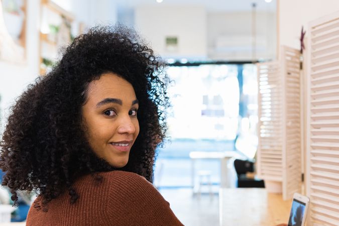 Black woman with smartphone in bar