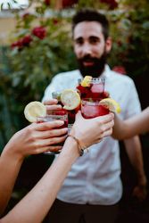 Group of cheerful friends clinking glasses at party