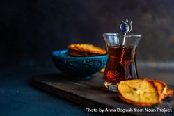Dried persimmon slices surrounding Turkish tea bDjVpA