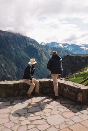 Two people overlooking view in the Andes