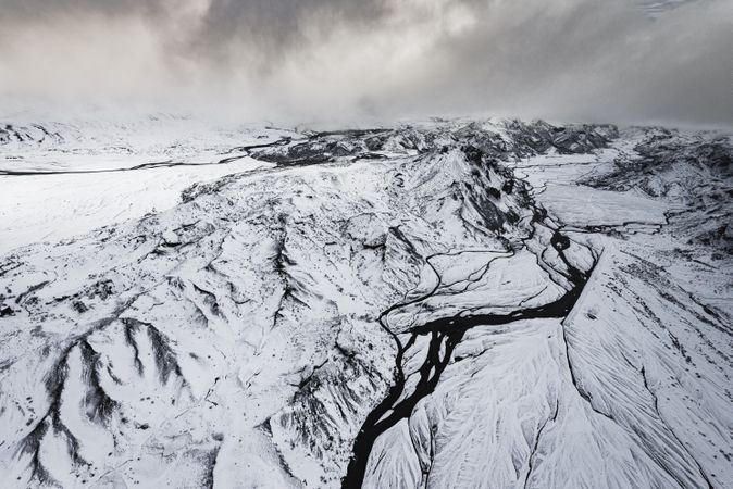 A stark river running through a wintry hill in remote Iceland