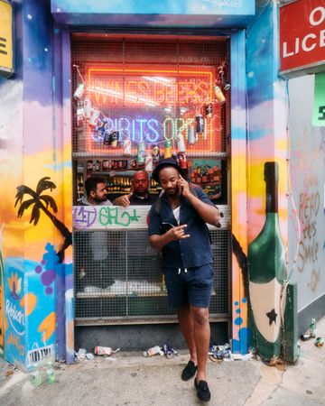 London, England, United Kingdom - August 28, 2022: Man outside liquor store at Notting Hill Carnival