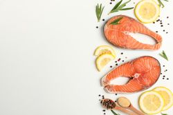 Composition with salmon meat and spices on light background, top view