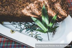 Close up of a baked grainy loaf with a marijuana leaf 47logb