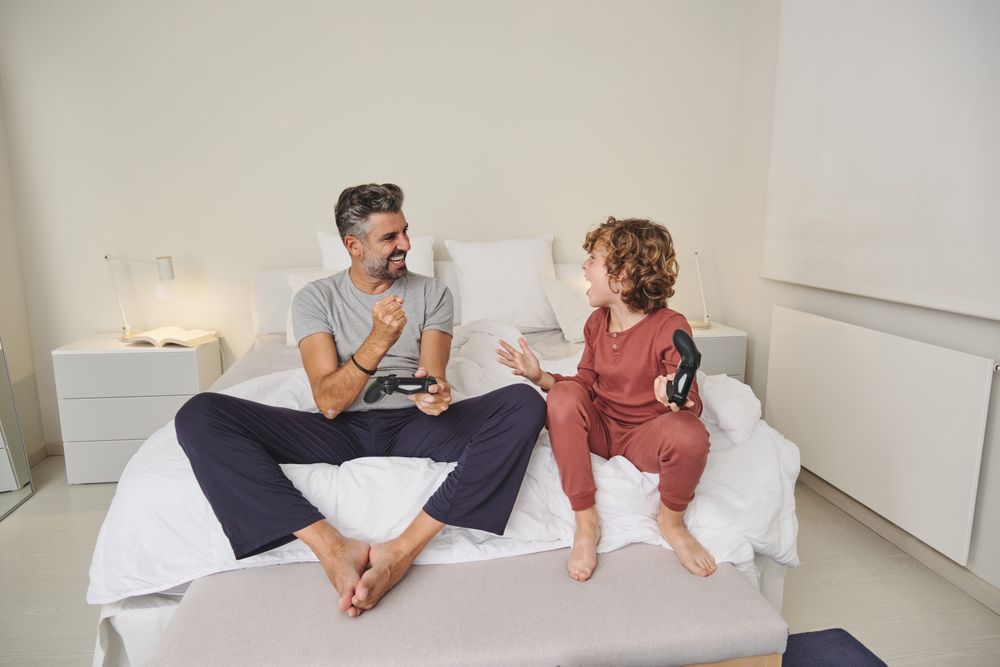 Cheerful boy and father discussing videogame