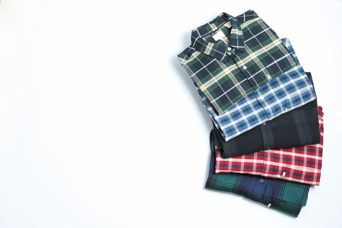 Different beautiful shirts on blank background, space for text