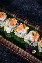 Yummy salmon tempura rolls served on plate in Japanese restaurant