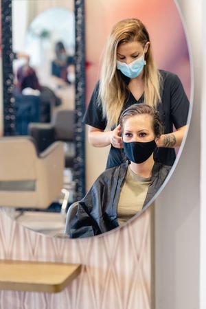 Woman getting her hair done by woman hairdresser
