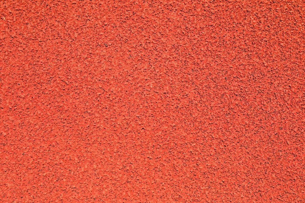 Red rubber running track background, top view
