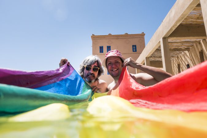Happy gay couple in swimming pool