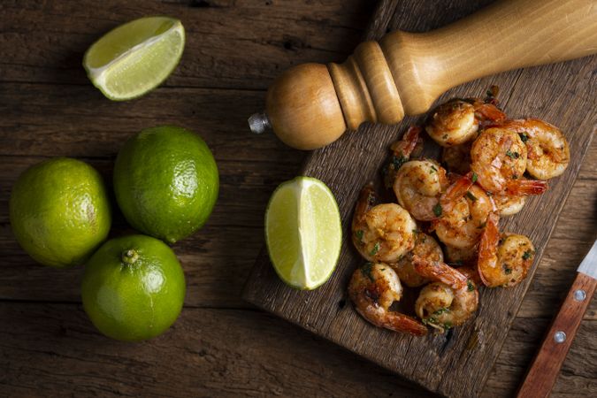 Delicious grilled prawns on wooden background.
