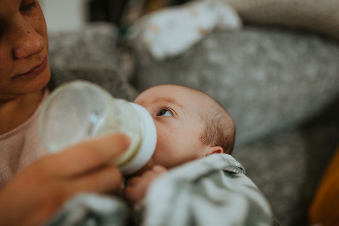 Newborn being bottle fed