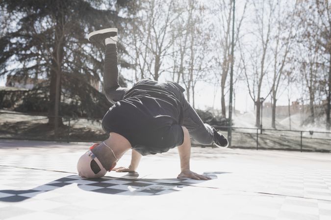 Man dancing break dance in park