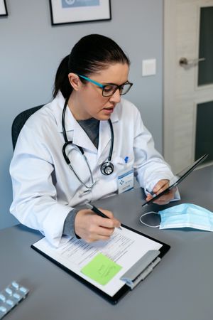 Female doctor doing online consultation with the tablet