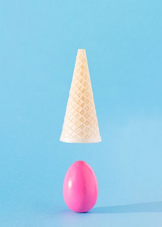 Pink egg with upside down ice cream cone above