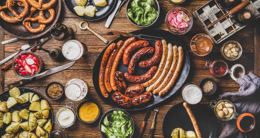 German sausages and pretzels displayed on wooden table