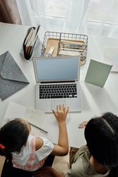 Top view of mother and child using laptop
