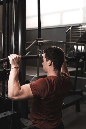 Young fitness man training in gym
