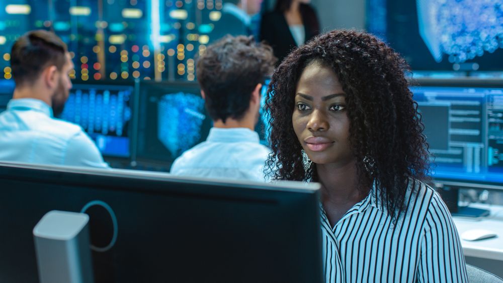 Female Computer Engineer Works on a  Project with Her Multi-Ethnic Team of Specialist.