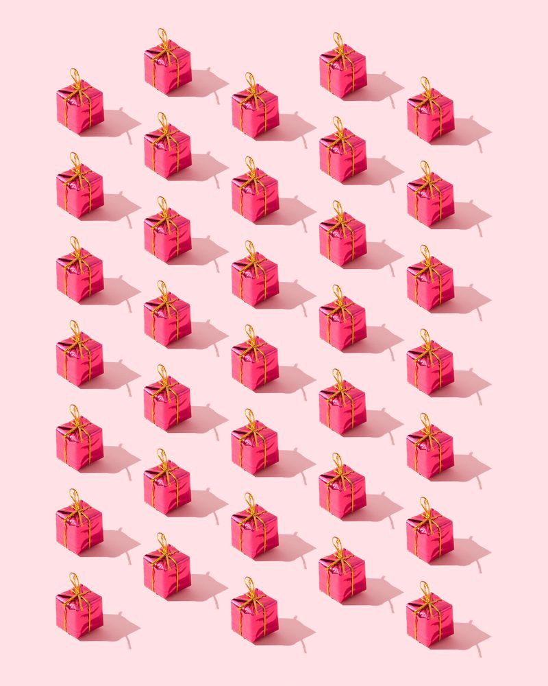 Many red presents over pink background