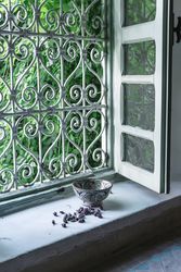 Dried flower buds and bowl near window