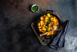 Pot of Georgian meat and vegetable dish Souzi served with herb, with copy space