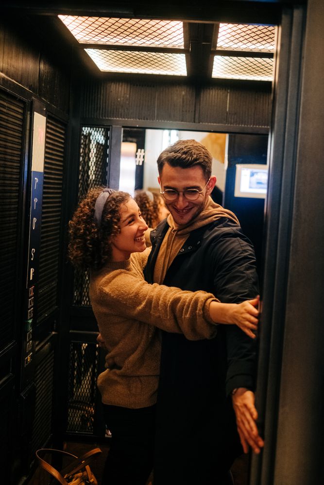 Happy couple standing in elevator