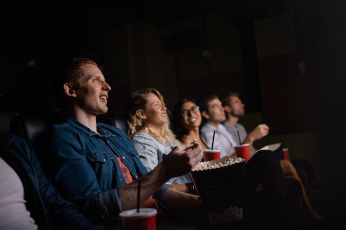 Young people watching movie in a movie theater