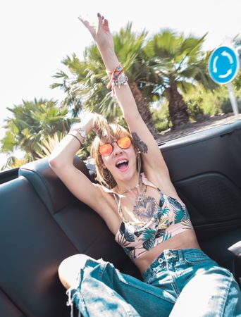 Young woman riding cabriolet